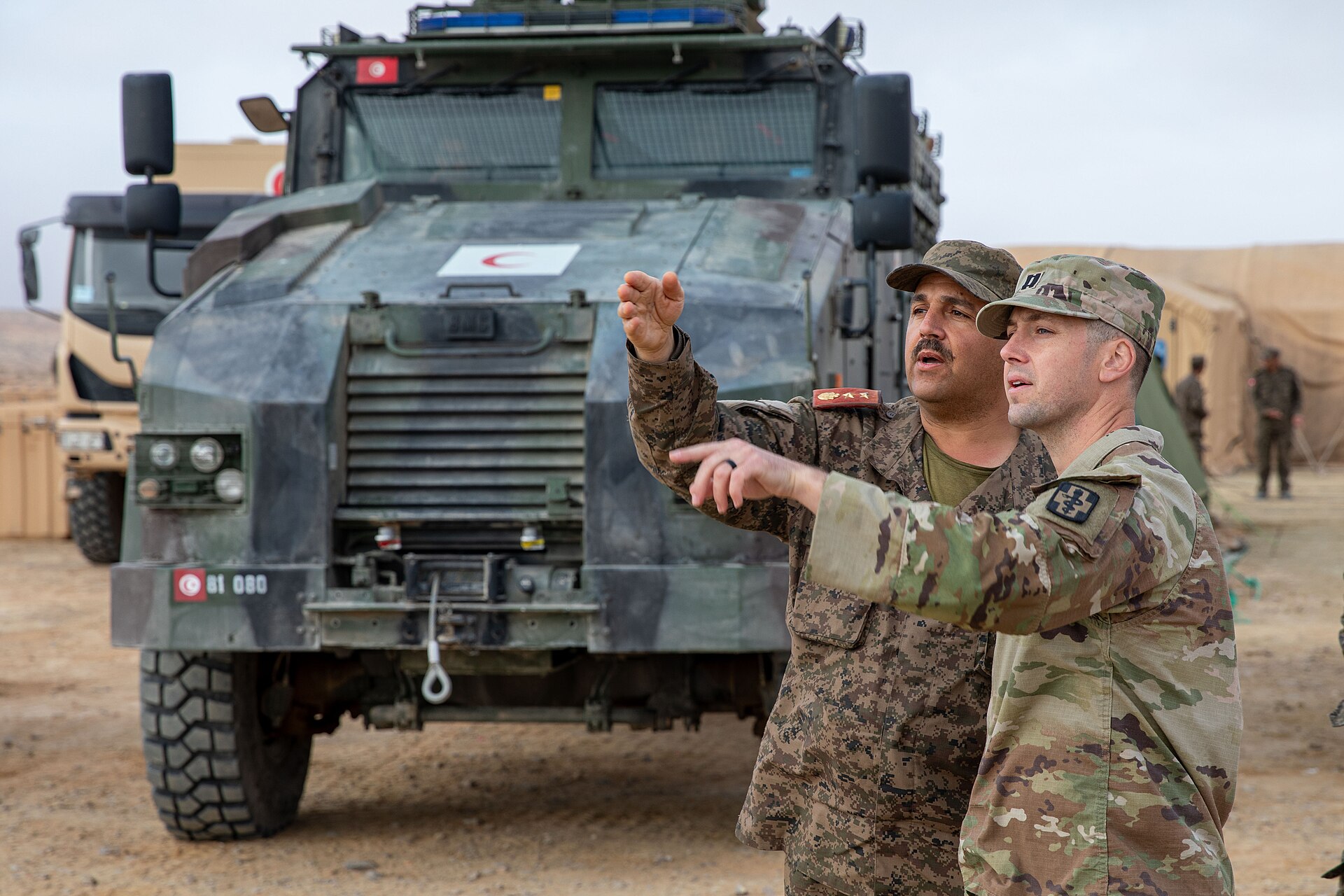 Tunisian army armoured ambulance consistent with the BMC Kirpi 4x4 ambulance at a training area