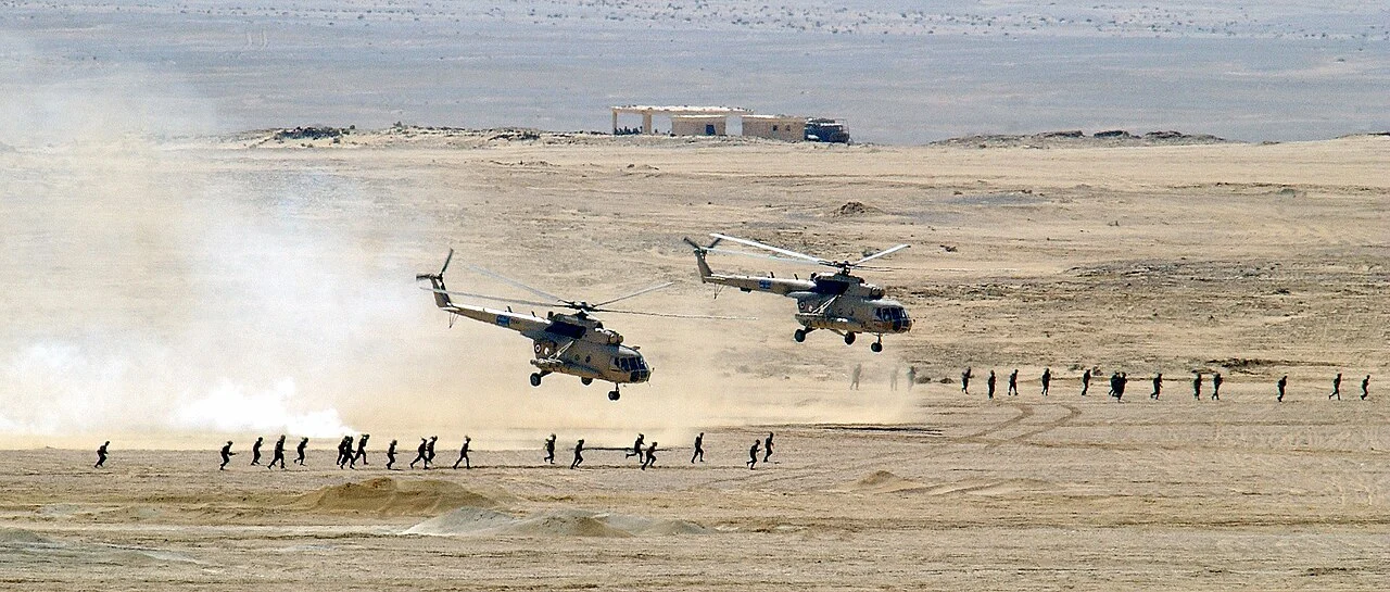 Egyptian Air Force Mi-8 Hip helicopters lifting off after unloading troops
