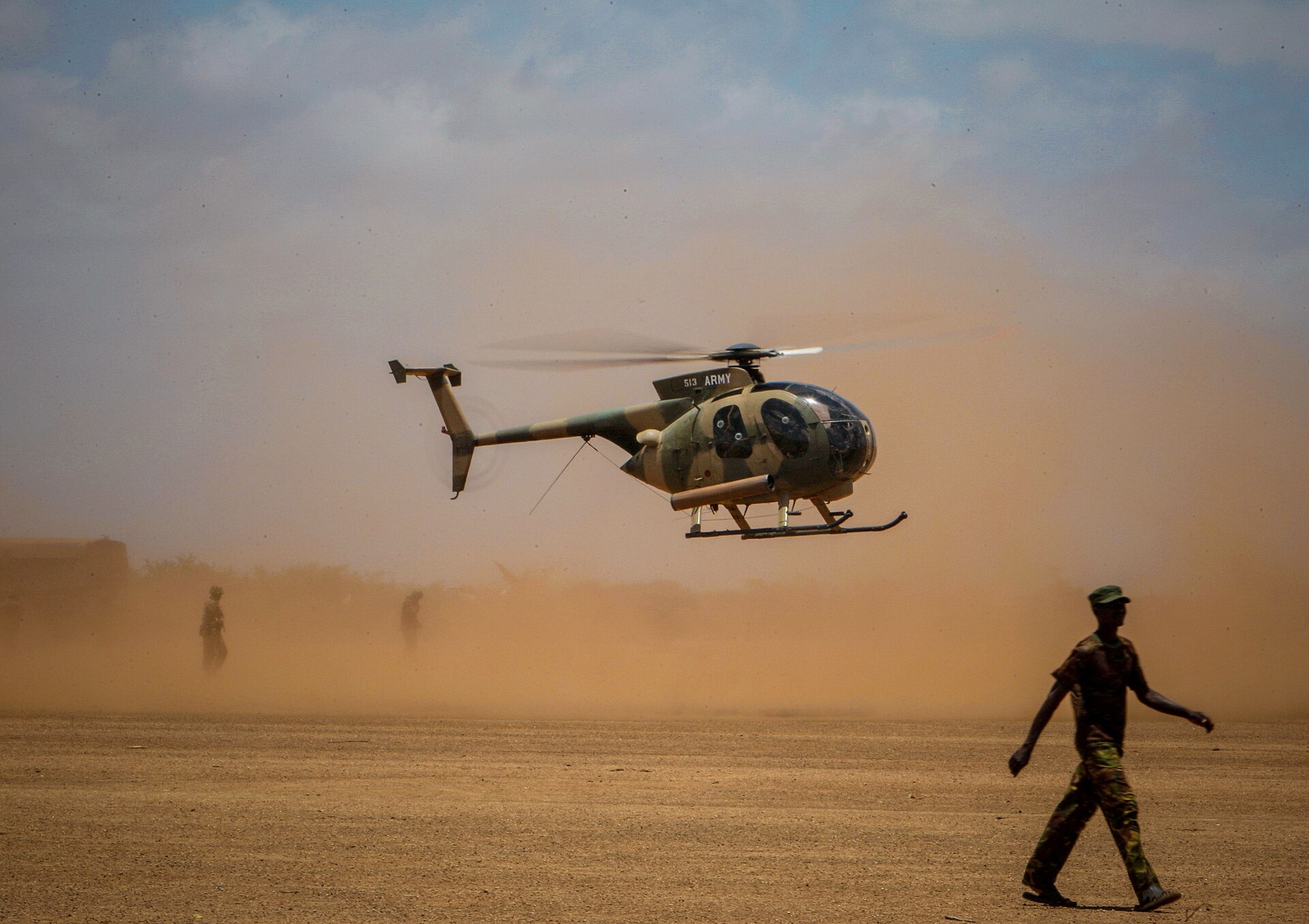 Kenya Army MD 500 Defender helicopter landing in dust at Kismayo, Somalia, October 2012