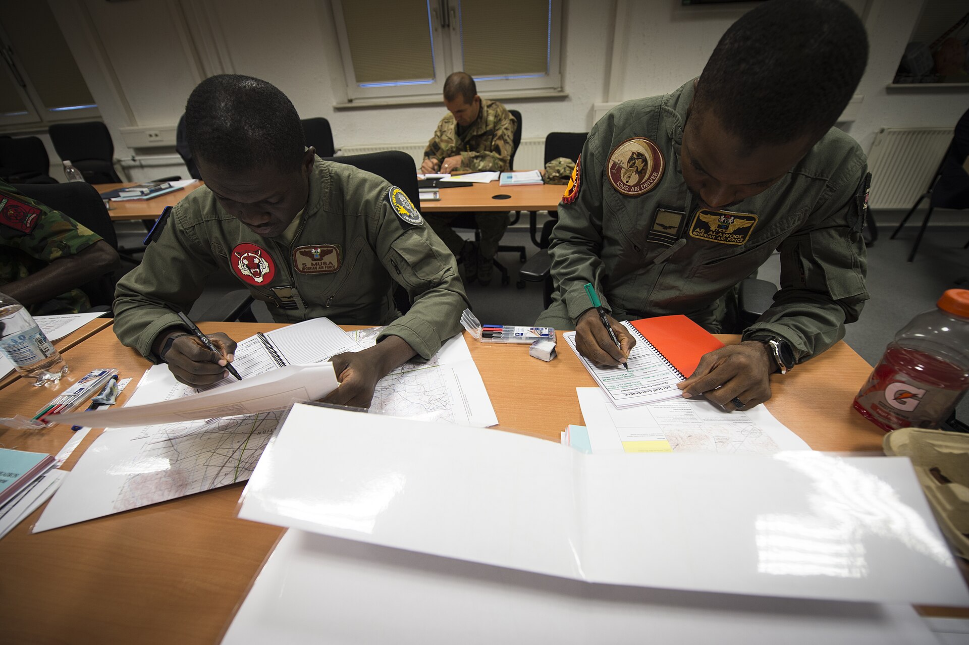 Two Nigerian Air Force pilots planning a simulated mission during a US-run air-to-ground integration course in Germany, 2019