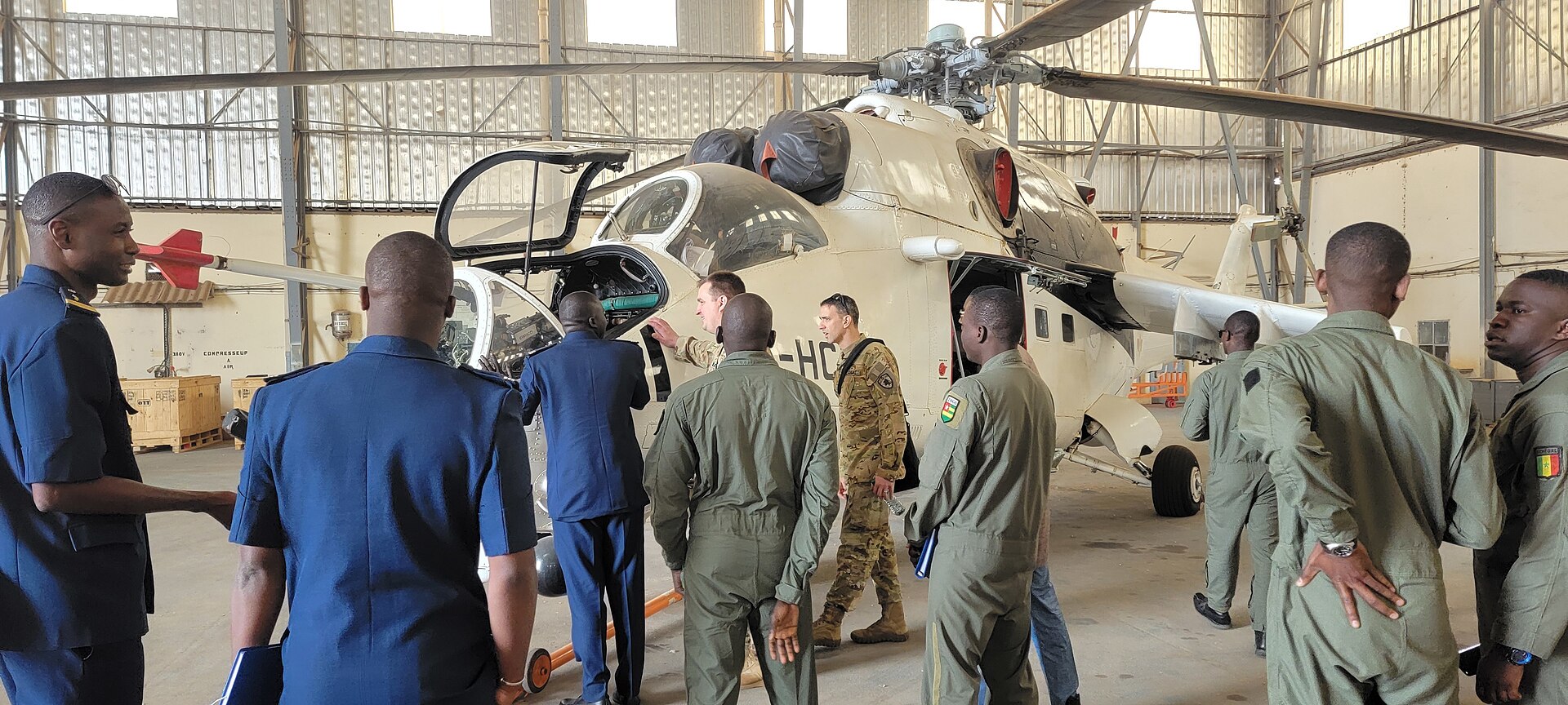 Senegalese Air Force Mi-24 attack helicopter in a hangar with Senegalese and US National Guard aviators, March 2022